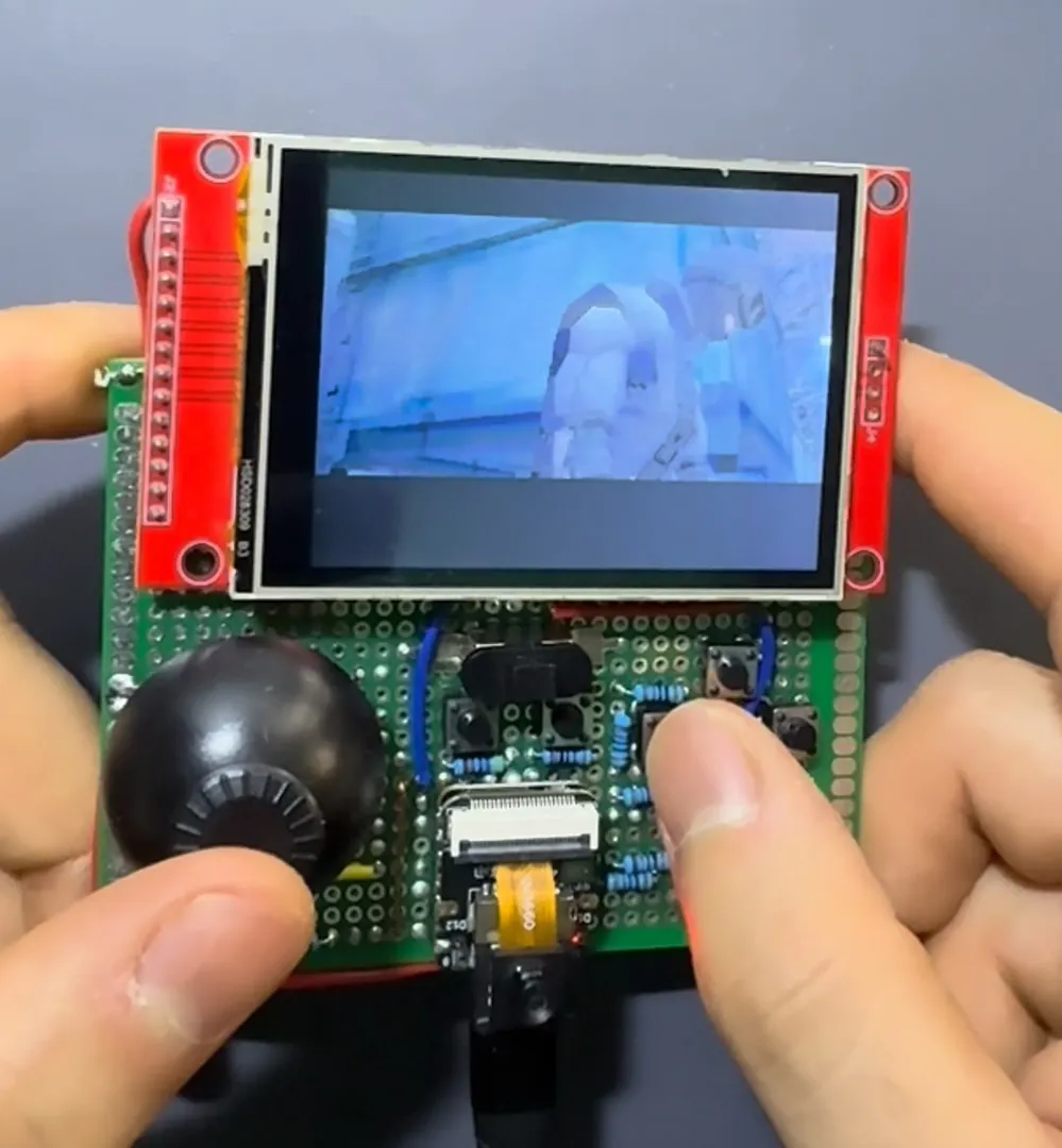 The assembled handheld on perfboard: the analog stick on the left, the button ladder's resistors in the middle and the XIAO at the bottom
